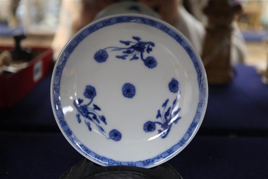 An 18th century Chinese blue and white tea bowl and saucer, and a similar bowl and two hardwood stands